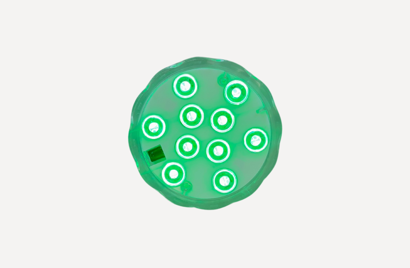 Top view of green submersible LED spa light for Tubble bathtubs.