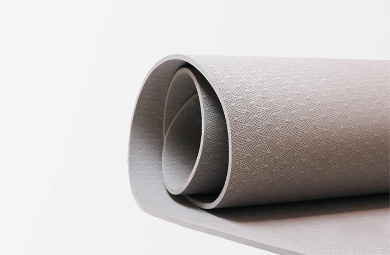 Roll of textured silver paper on a white background