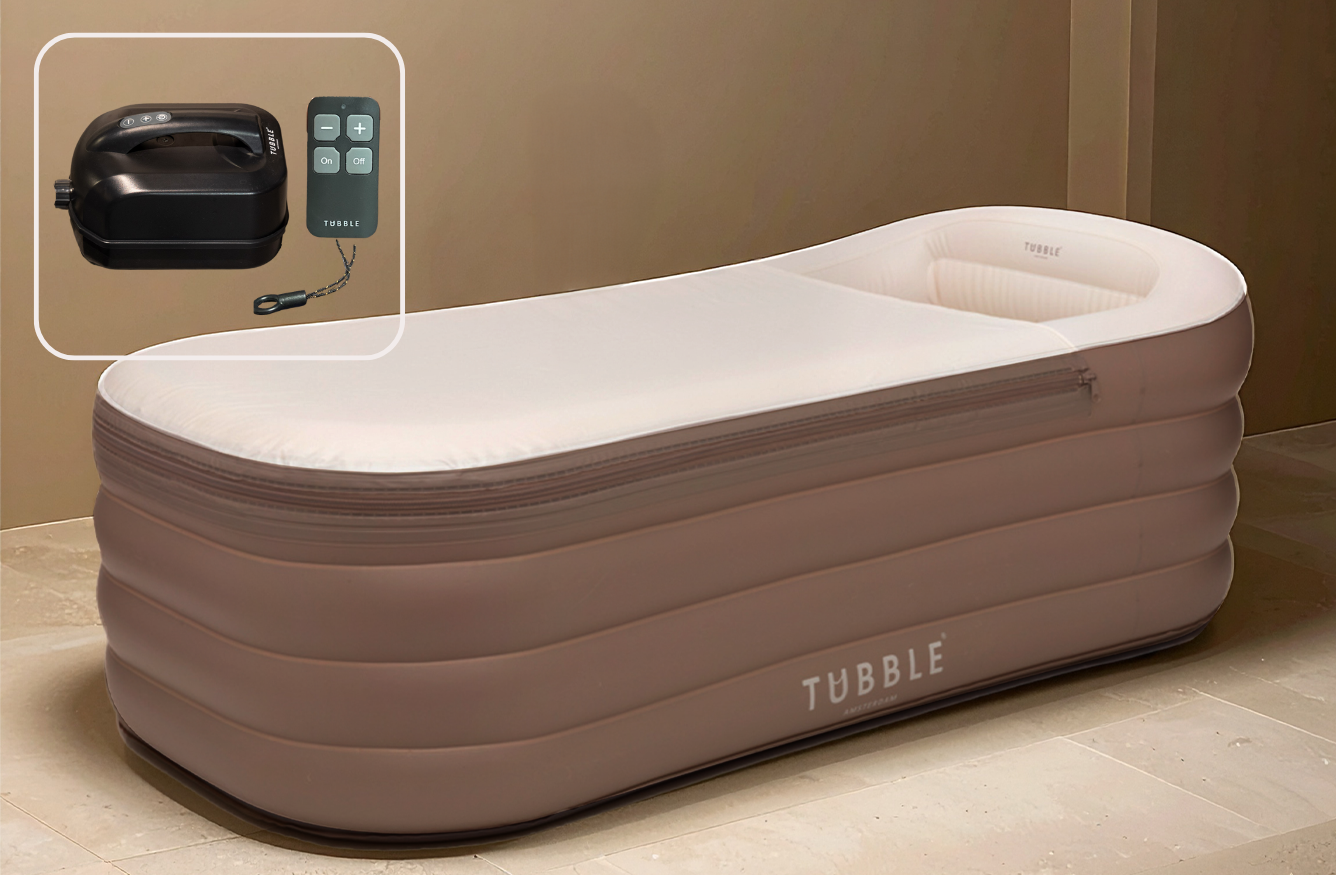 A portable jacuzzi bath with integrated bubbles, soft sides, headrest, and a control panel. The product is set against a beige background and has 'TUBBLE' branding visible.