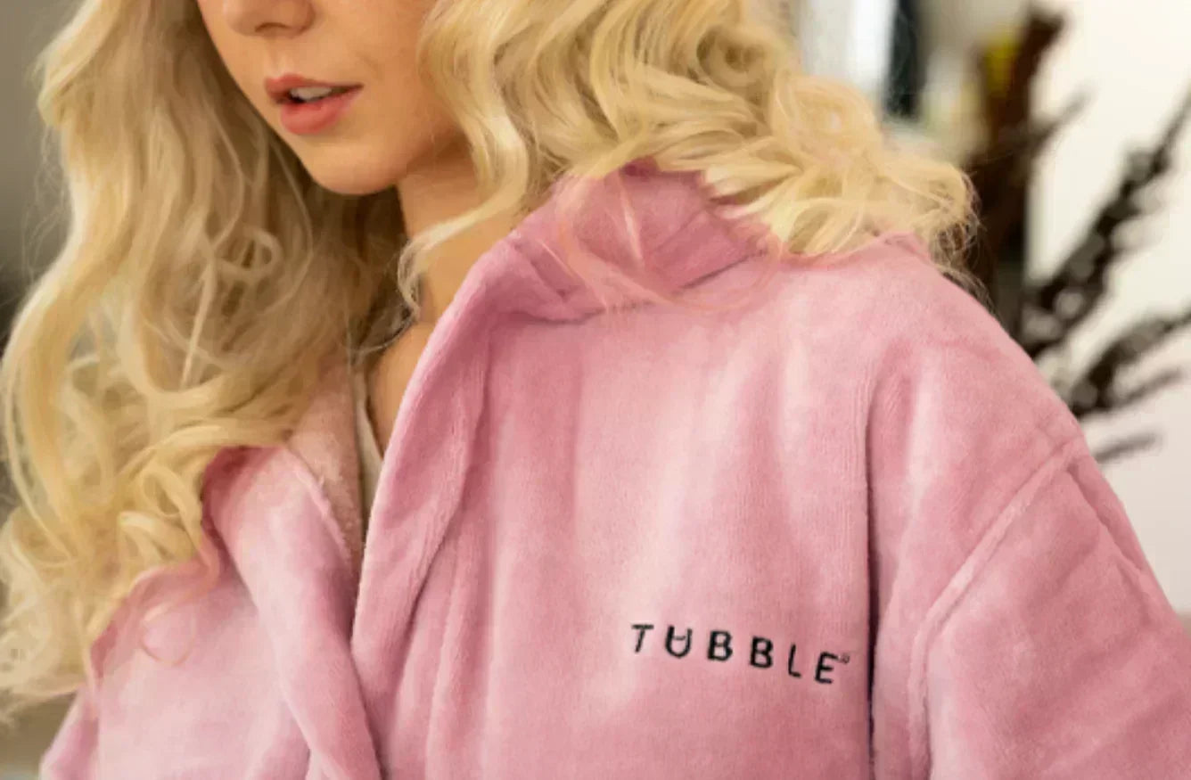 Person wearing a pink robe with 'Tubble' branding